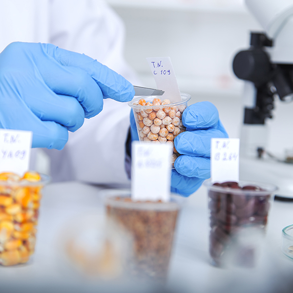 Person in a lab coat measuring ingredients